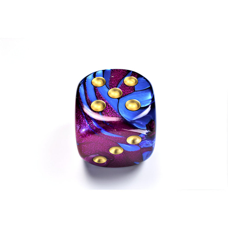 A Chessex Gemini vibrant purple and blue marbled d6 dice with gold pips, showing five on top and three on its side