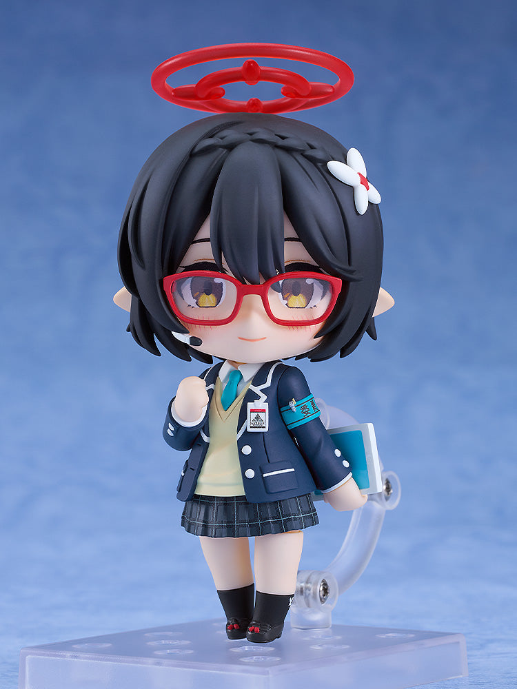 A Nendoroid figure of a black-haired character with red glasses, red halo, and school uniform, holding a book