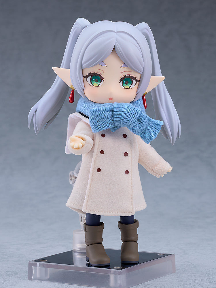 Good Smile Company Nendoroid Doll Frieren figure in a cream coat blue knitted scarf brown boots and pigtails standing on a clear base