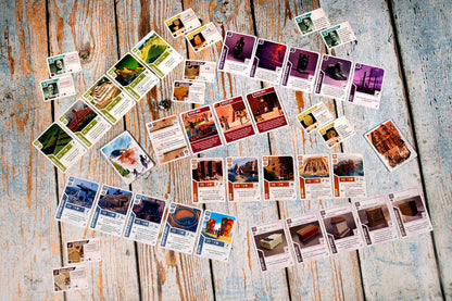 Ancient Knowledge Heritage board game showing game cards with archaeological sites artifacts and historical figures on a wooden table