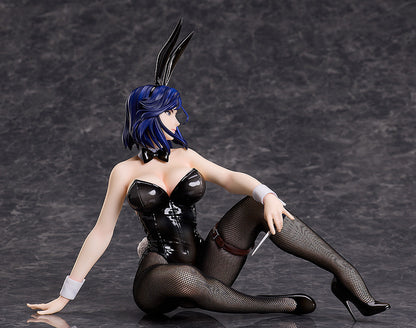 Blue-haired anime figure in black bunny suit, fishnets, and heels, seated, holding a dagger