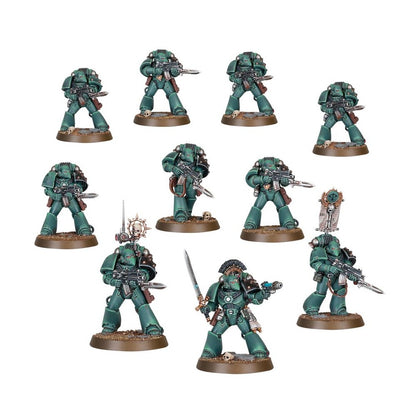 Nine dark green miniature Space Marine infantry models with rifles and squad leader equipment on scenic bases