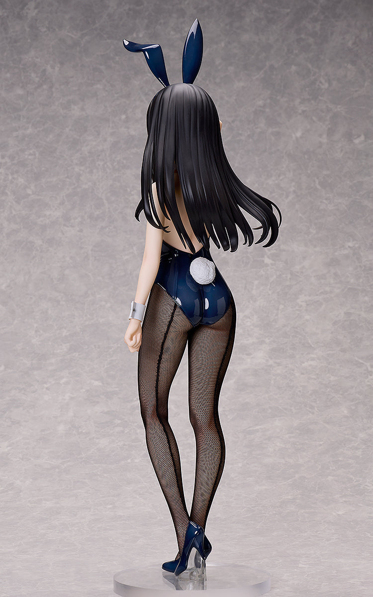 A Takina Inoue bunny version figure from the back, showing dark hair, bunny ears, a dark blue suit with a white tail, fishnet stockings, and high heels