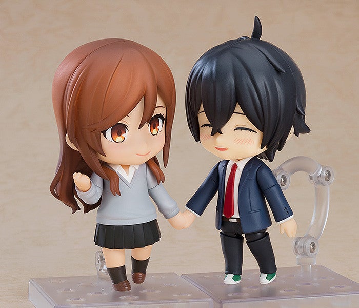 Two Nendoroid figures of a couple from Horimiya the girl in a gray uniform
