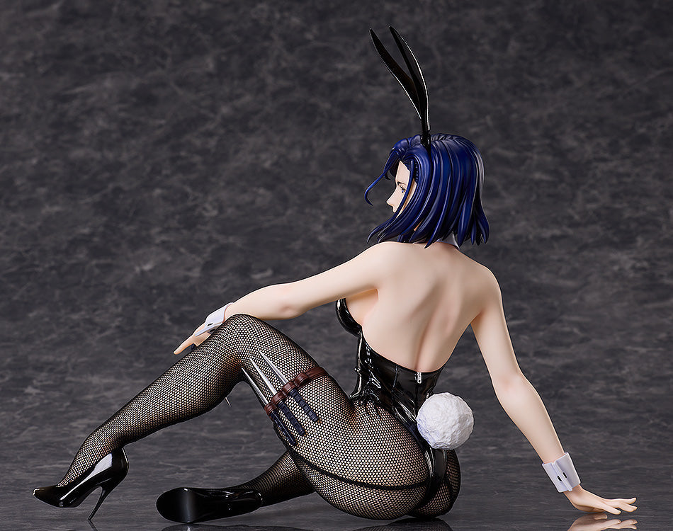 Figurine of a woman with dark blue hair in a shiny black bunny suit, fishnet stockings, and heels, reclining with blades on her thigh, looking back