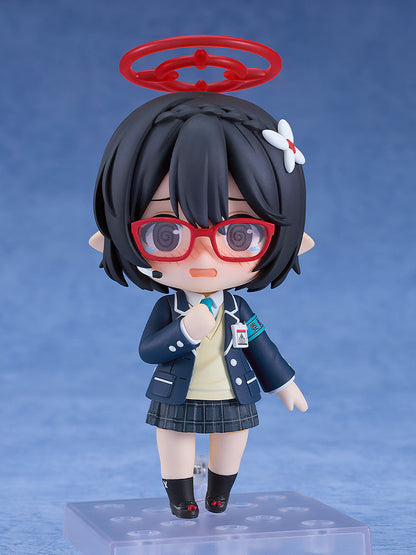 Chibi anime girl figure in a school uniform, with red glasses and halo, crying with a hand to her chest