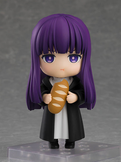 Frieren Beyond Journey's End Nendoroid Fern figure holding a brown baguette wearing a black coat over a white top against a gray background