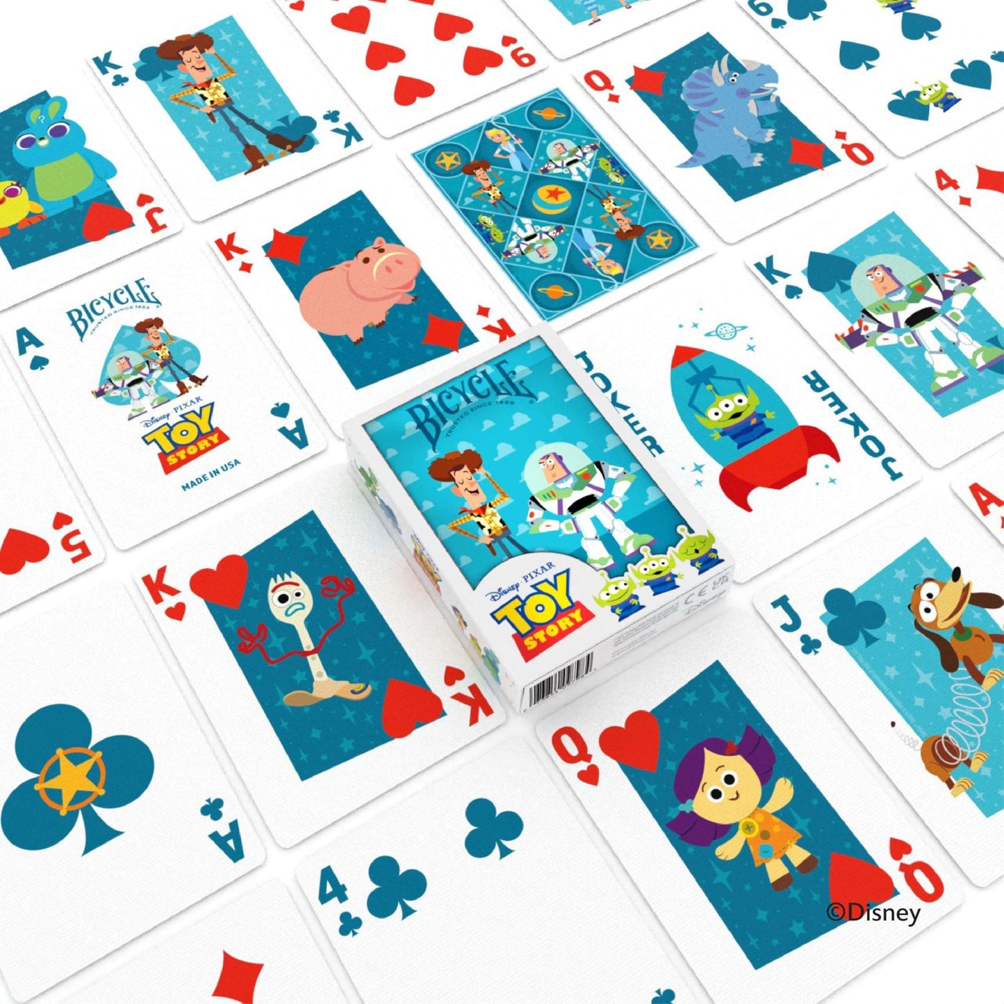 Bicycle Disney Pixar Toy Story playing cards are scattered around the blue tuck box, featuring colourful illustrations of Woody Buzz and other characters