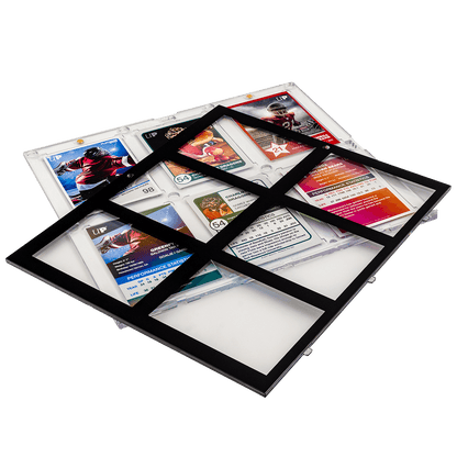 A clear 6-card holder with a black border displays various sports trading cards in its compartments