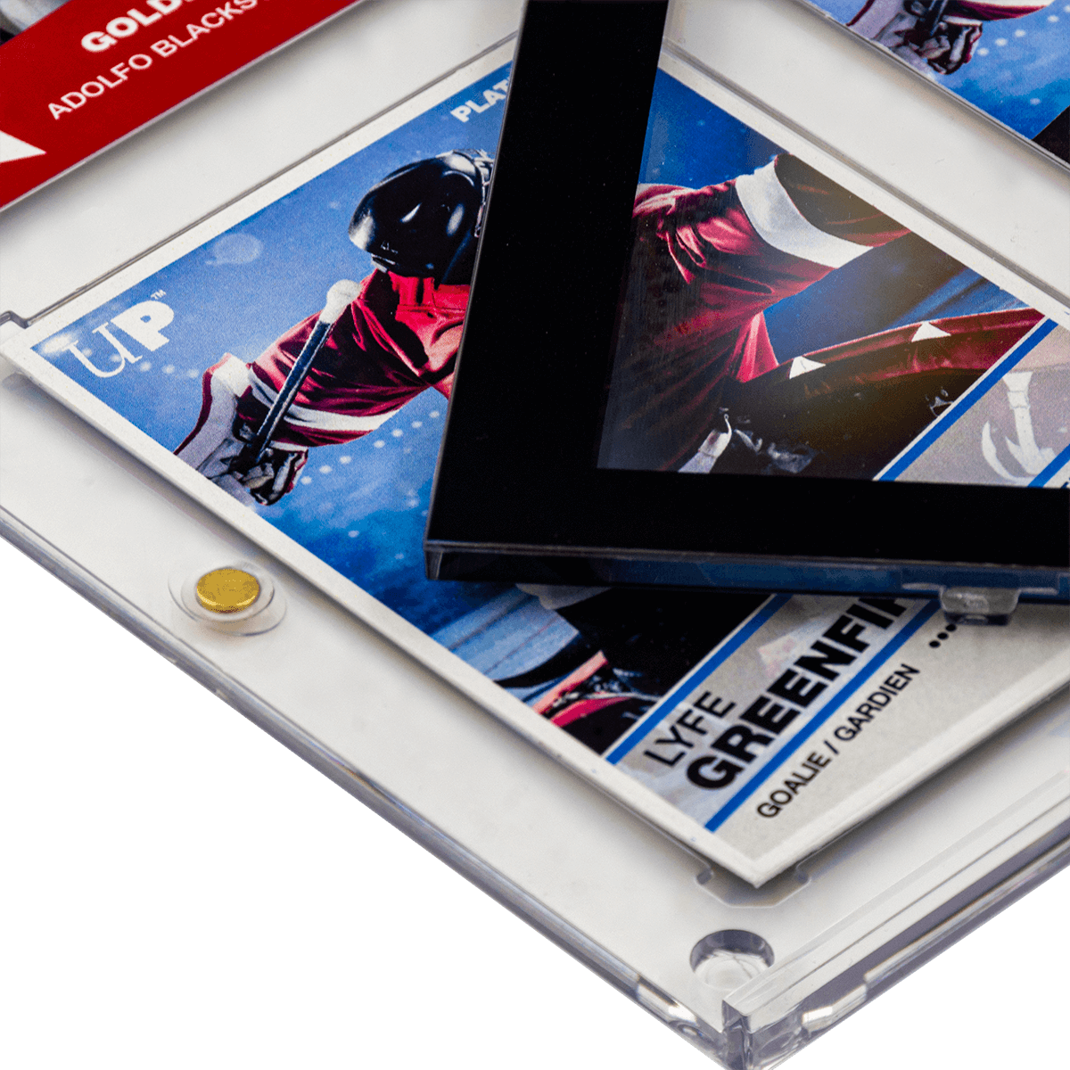 A stack of hockey cards in clear Ultra Pro One Touch protectors, one featuring a black border around a player in a red jersey