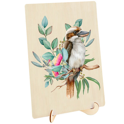 Watercolour Kookaburra bird on a branch surrounded by pink Australian bottlebrush and eucalyptus leaves, printed on a light wood plaque with a stand