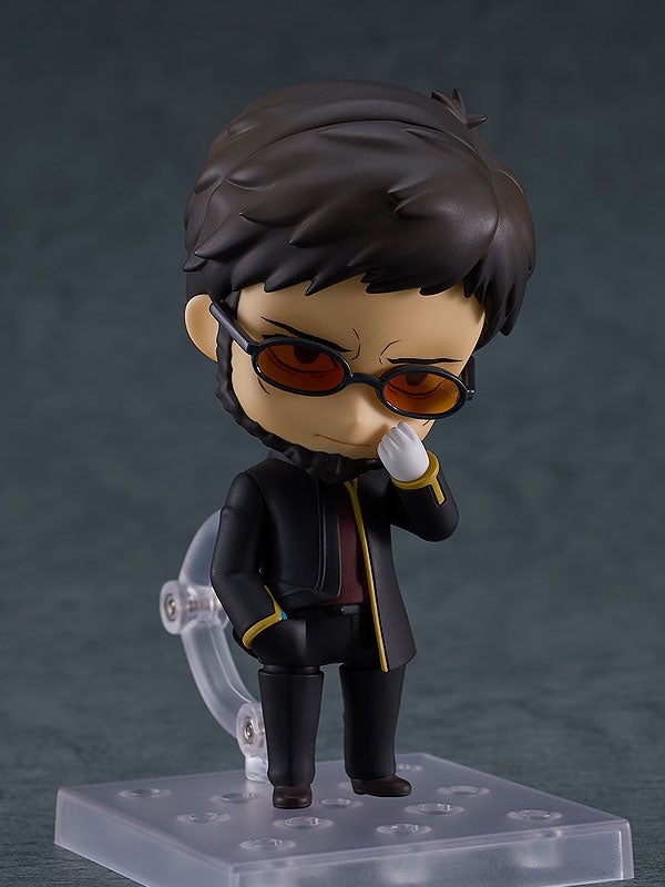 Nendoroid figure of a man with dark hair, sunglasses, and a goatee, in a black jacket, hand to face