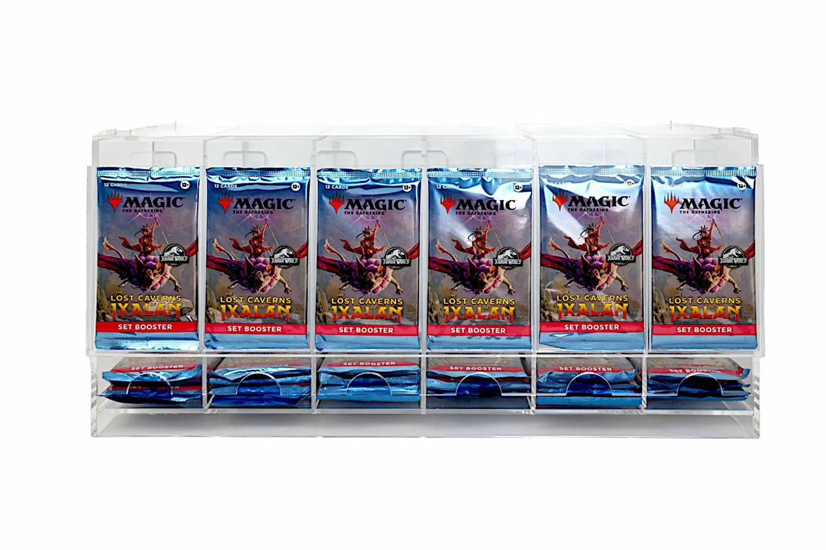 A clear acrylic display stand holds multiple "Magic: The Gathering: Lost Caverns of Ixalan" Set Booster packs