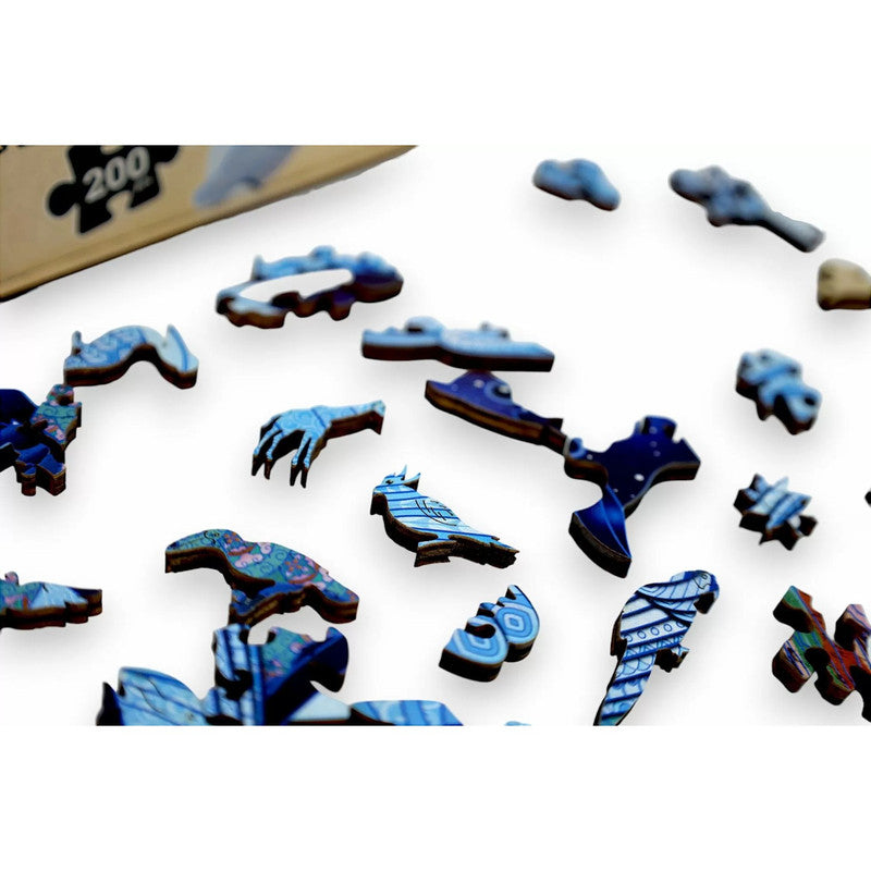 Wooden puzzle pieces with unique shapes (birds, hand) and blue patterns, scattered on white. A &#39;200&#39; box is visible