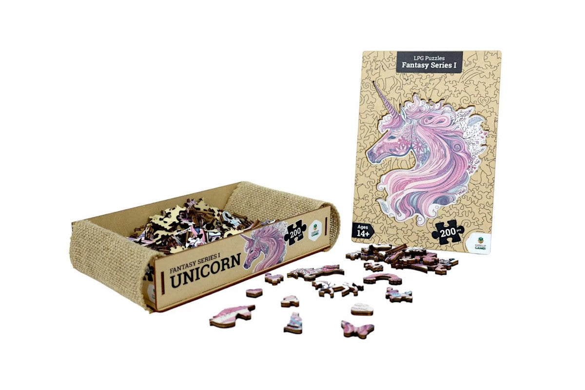 A wooden jigsaw puzzle of a pink unicorn, pieces are in a burlap-lined box, some scattered, and the completed image is shown