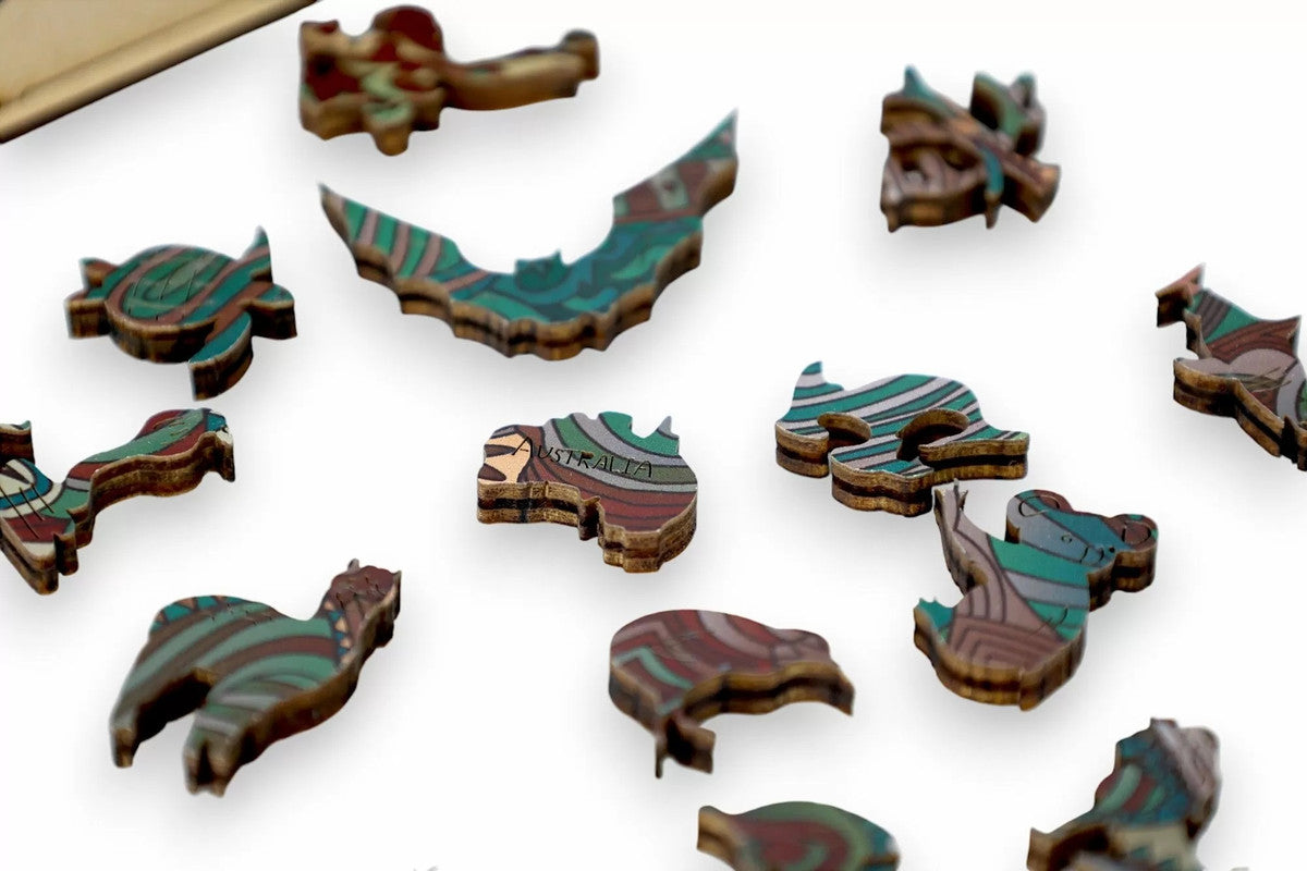 Scattered colourful wooden puzzle pieces, including Australia and animal shapes