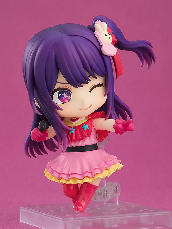 Ai figure holding a microphone with alternate expression, capturing idol performance moment