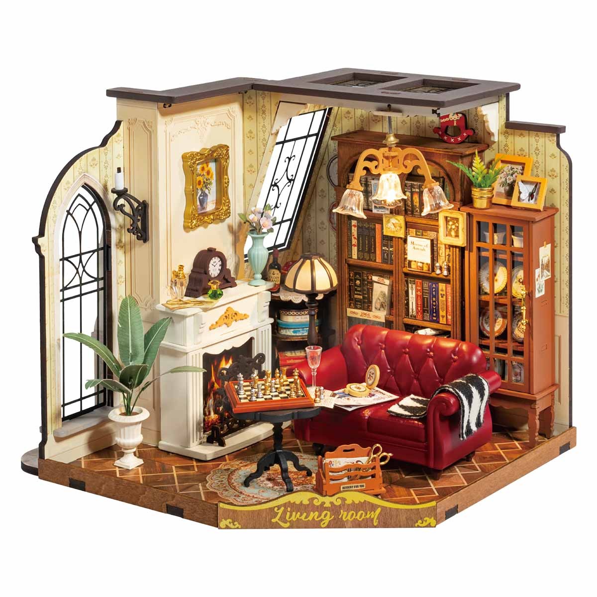 Detailed miniature model of a cozy Catherines living room with a red sofa, fireplace, bookcase, and chessboard