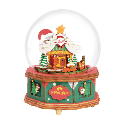 Rolife wooden Christmas music box snow globe featuring a colorful Santa's workshop scene