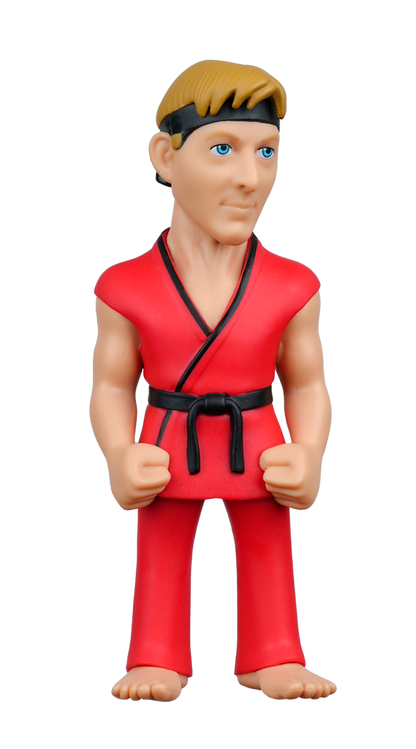 A MINIX Eagle Fang Karate figure of a blonde man with a black headband, blue eyes, wearing a red gi with a black belt, standing with fisted hands