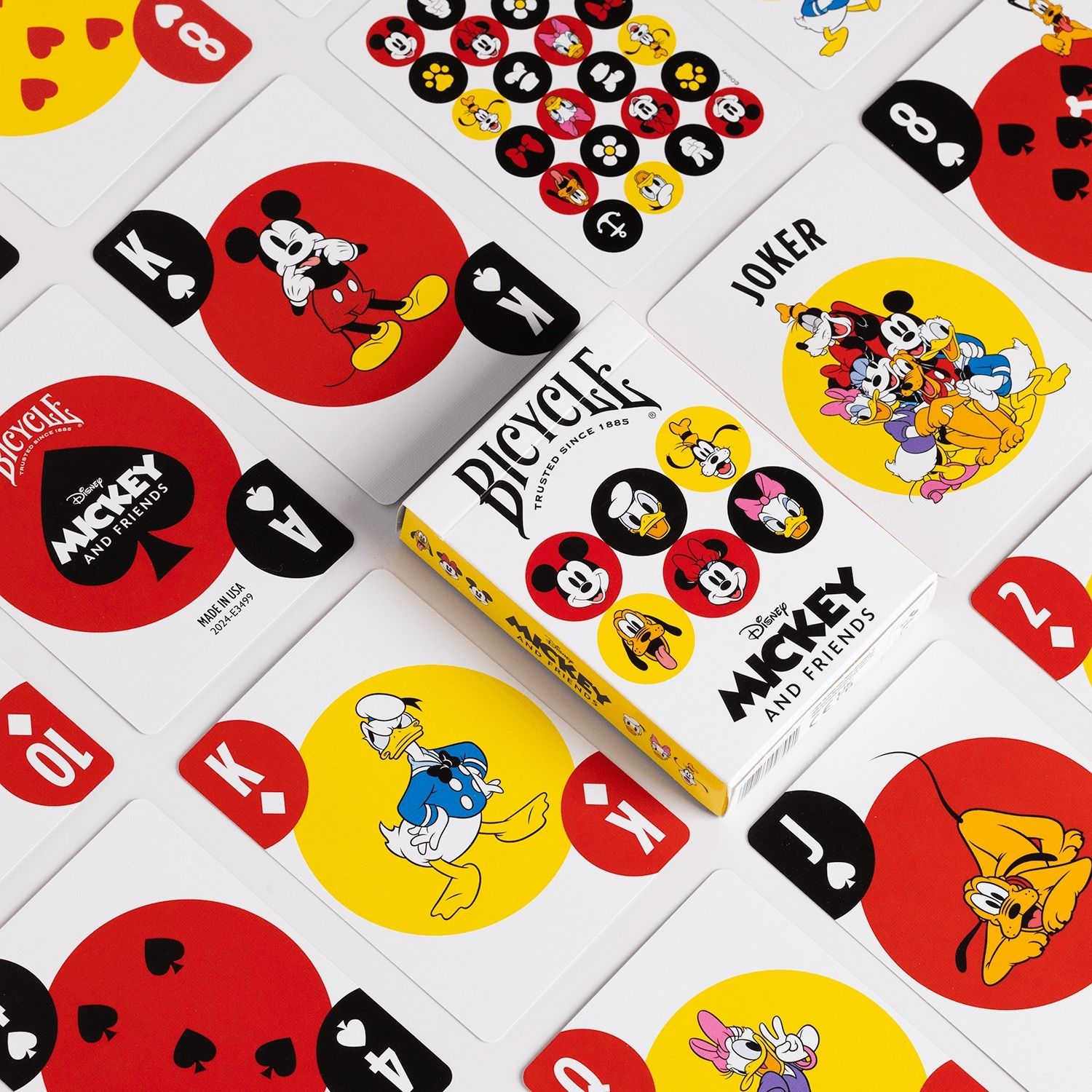 Bicycle "Mickey and Friends" playing cards spread around the white deck box, featuring various Disney characters