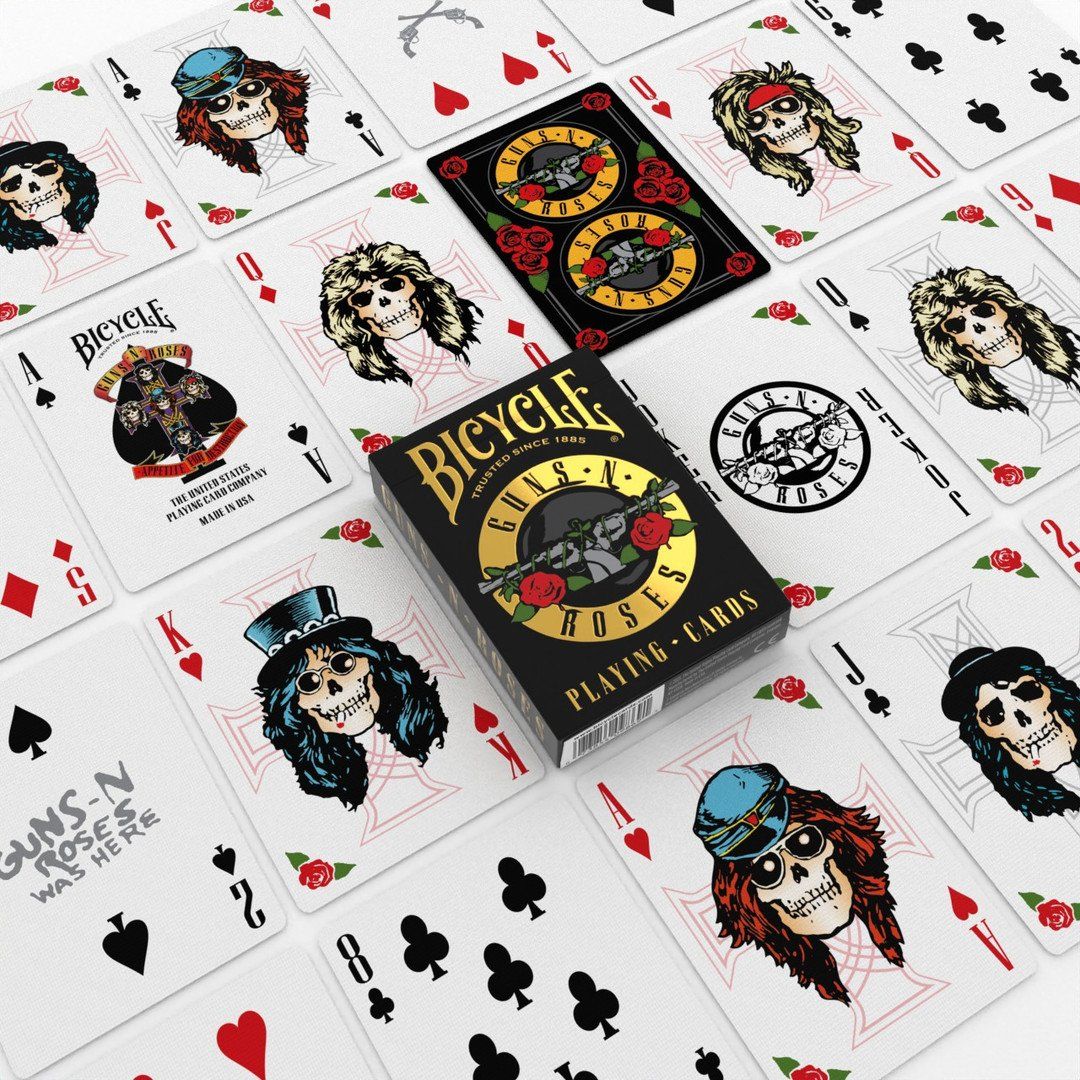 Bicycle Guns N' Roses playing cards spread around the black card box, featuring skull artwork and band logos