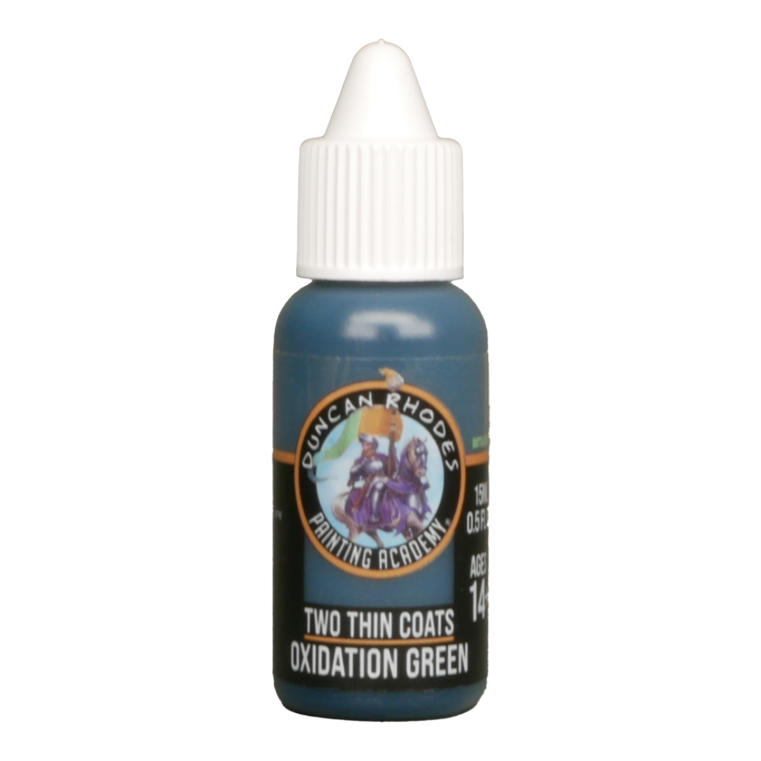 A bottle of Duncan Rhodes "Two Thin Coats Oxidation Green" hobby paint with a white dropper cap