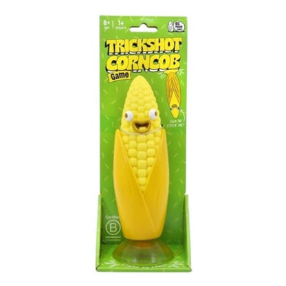 Cartoonish yellow corncob toy with a face, packaged for the "Trickshot Corncob Game"