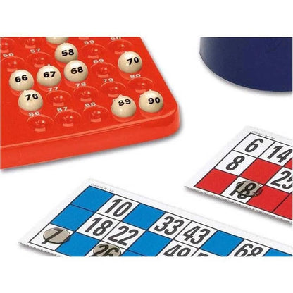 Numbered Bingo balls on a red board next to blue and red Bingo cards