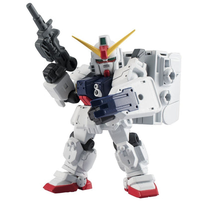 White, squat Gundam action figure holding a rifle and shield
