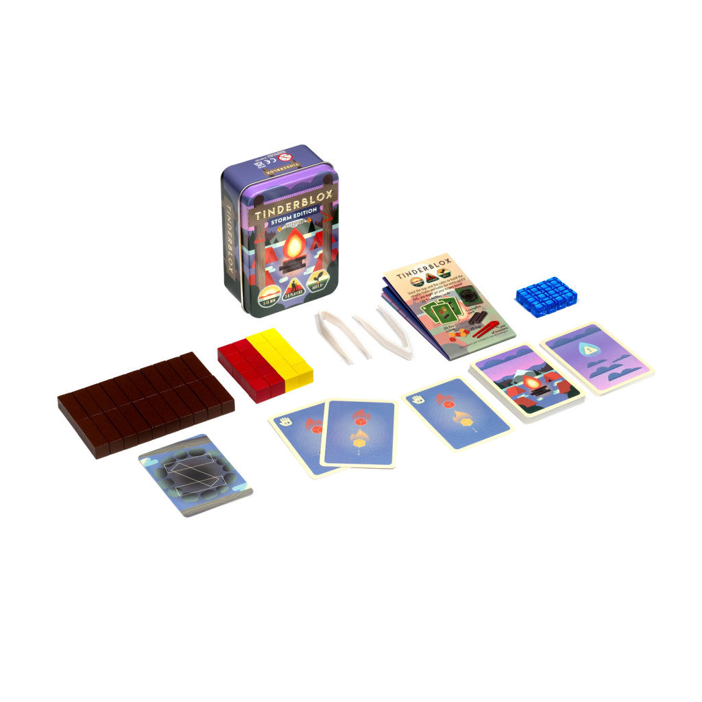 Tinderblox Storm Edition board game set, showing the tin box, wooden blocks, tongs, and cards