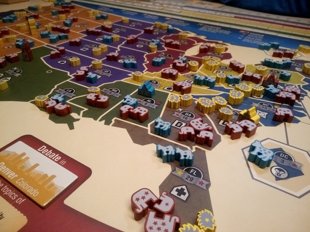 Overhead view of a political campaign strategy board game with pieces representing states candidates and campaign resources