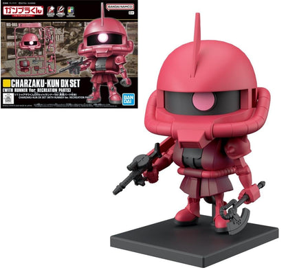 Red chibi Char Zaku figure holding a rifle and an axe, standing on a black base, with its product box visible