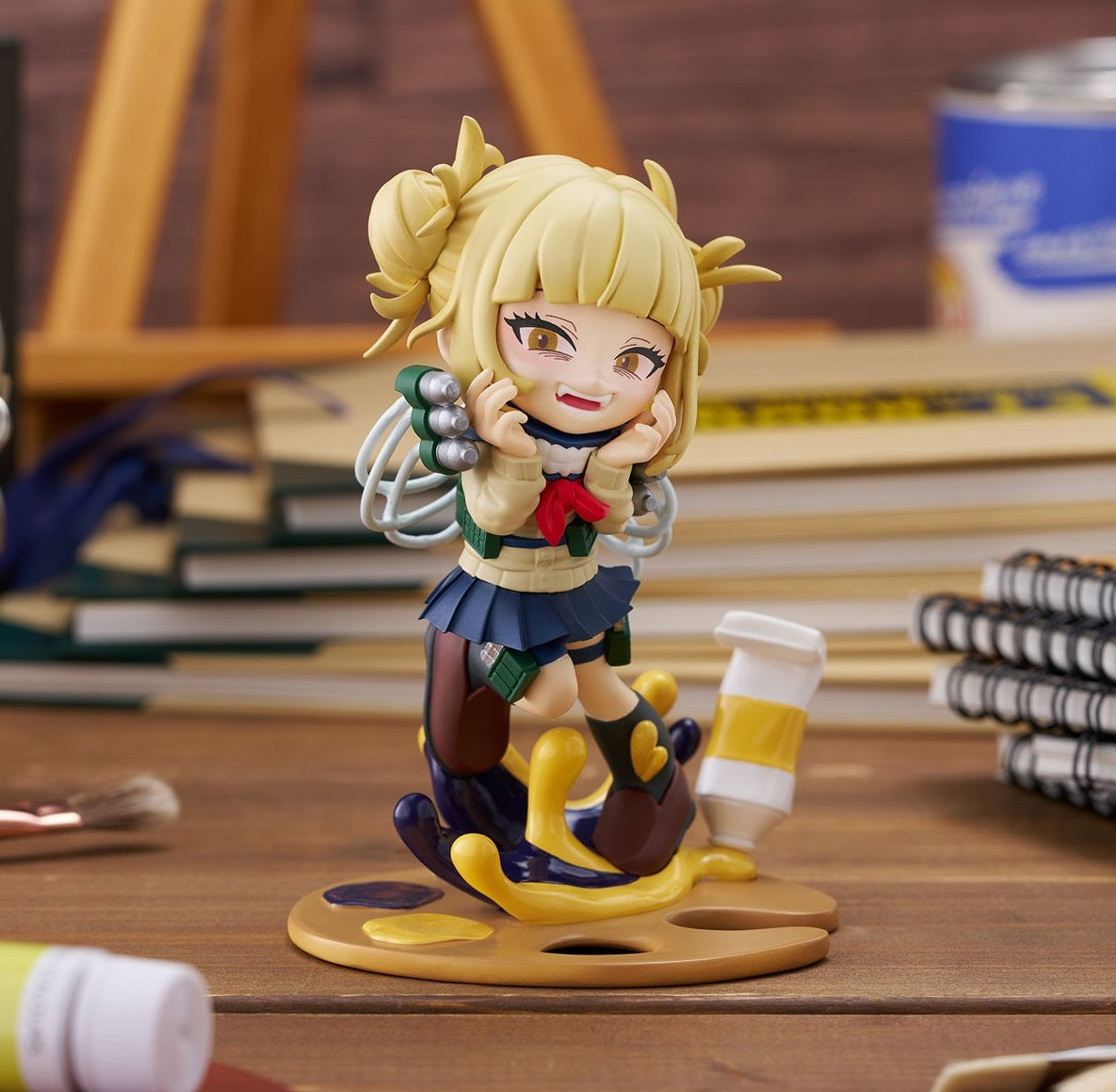 Mischievously smiling Himiko Toga Nendoroid in school uniform, standing on an artist's palette with spilled paint