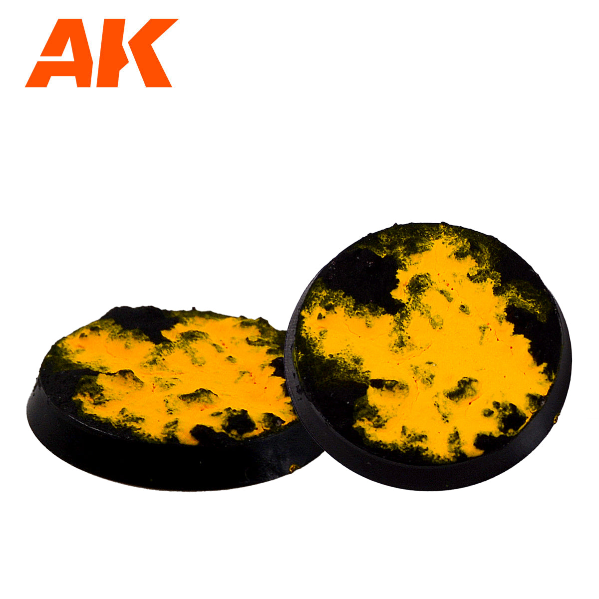 Two round black miniature bases with rough, bright yellow and black tops, resembling molten lava or fiery terrain