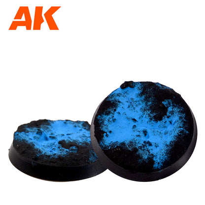 Two round miniature bases with textured black and vibrant blue cracked terrain