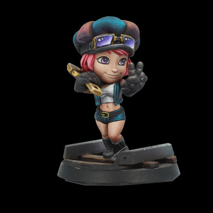 A miniature figurine of a pink-haired cartoon girl with goggles, smiling while holding a wrench and making a peace sign.