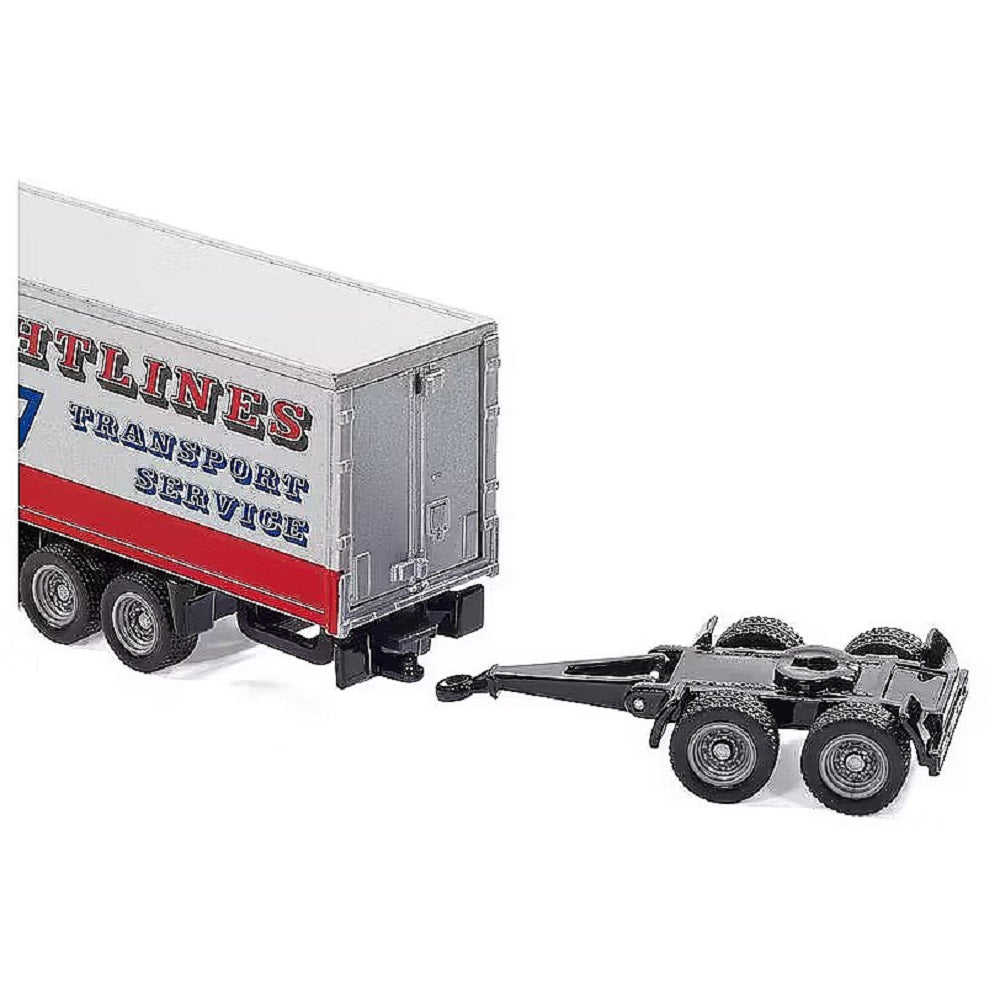 Model truck trailer rear connecting to a four-wheeled black trailer dolly (model scale)