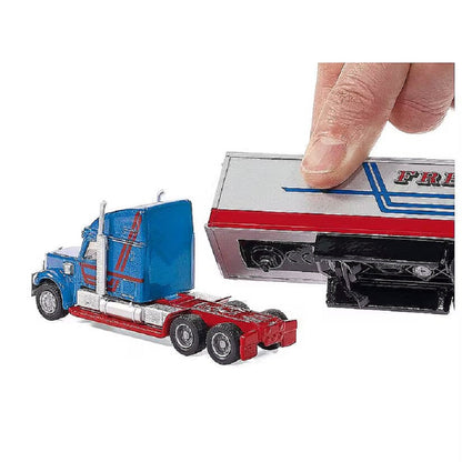 Miniature blue and red semi-truck cab with a hand connecting the silver toy trailer section