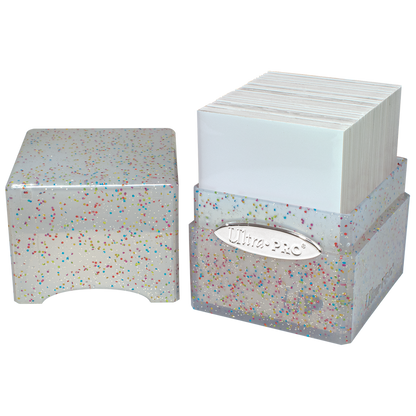 Ultra PRO glitter deck box holding sleeved trading cards. Clear plastic container with multicolored confetti and silver logo