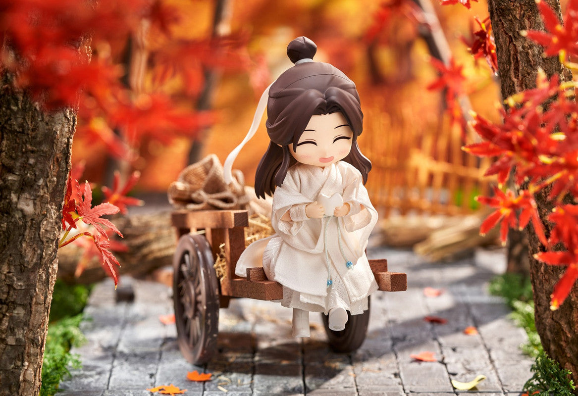 Nendoroid of Wen Kexing from Word of Honor sitting on a wooden cart in an autumn scene