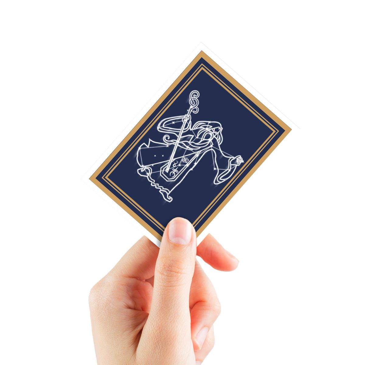 Hand holding a navy blue card with a gold border and white constellation line art symbol