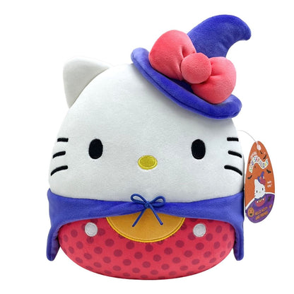 Hello Kitty Squishmallow plush dressed in a Halloween costume featuring a blue witch hat adorned with a pink bow, a blue cape, and a red polka-dot body