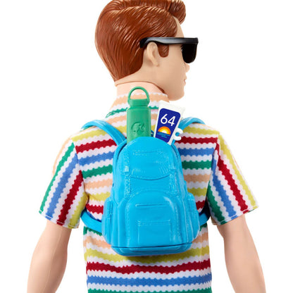 A male doll -  seen from behind -  wears a colorful striped shirt and sunglasses -  carrying a blue backpack with a green water bottle