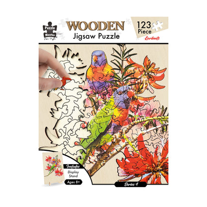123-piece wooden jigsaw puzzle of colourful lorikeets among red flowers, partially built, with a hand placing a puzzle piece