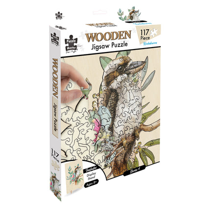117 Piece Kookaburra Wooden Jigsaw Puzzle box art, hand placing a unique, animal-shaped piece