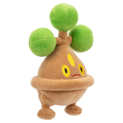 Official Pokémon Bonsly plush toy featuring a textured brown body, yellow embroidered eyes, and three fuzzy green spheres standing against a white backdrop