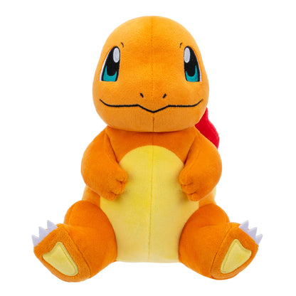 Studio shot of an adorable sitting Charmander plush toy with soft orange fur, a yellow tummy, and large blue embroidered eyes