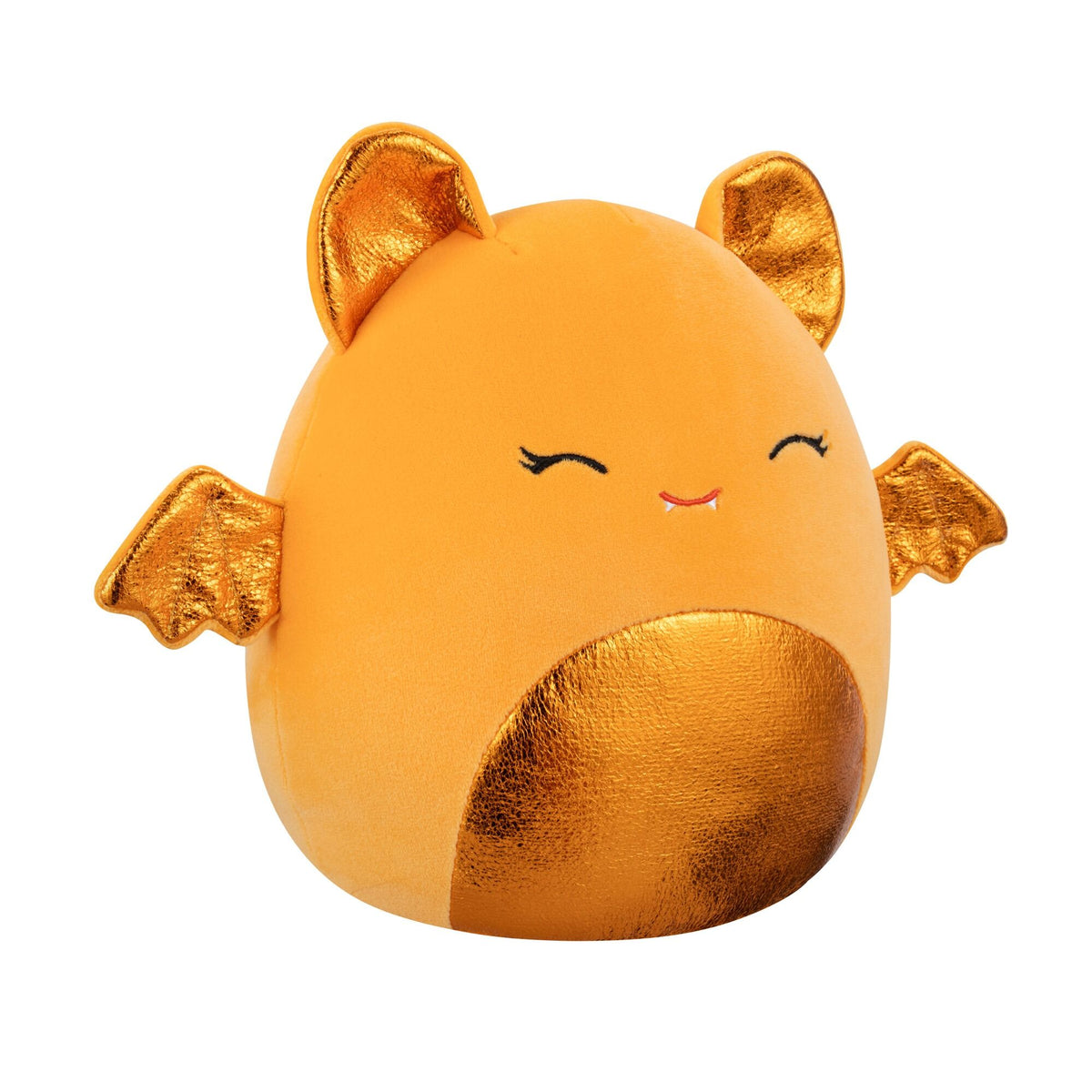 An orange Squishmallow plush toy with gold metallic ears, bat wings, a shiny belly, closed eyes, and a small fanged smile