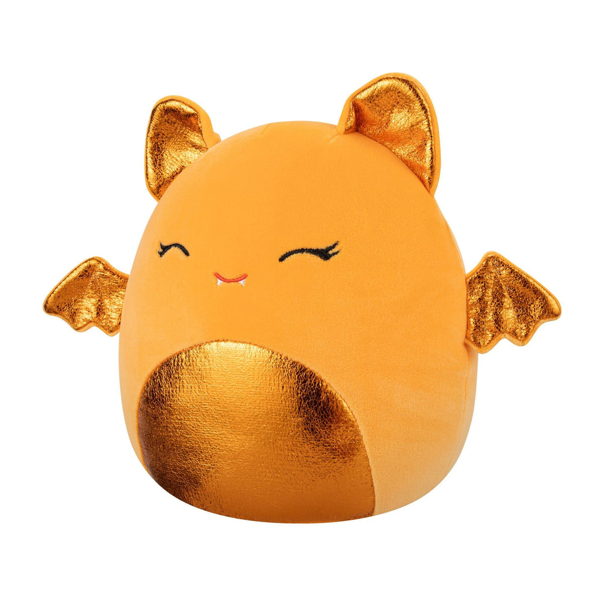 An orange Squishmallow plush toy resembling a bat with shiny gold ears, wings, and belly, featuring sleepy embroidered eyes and a fanged smile